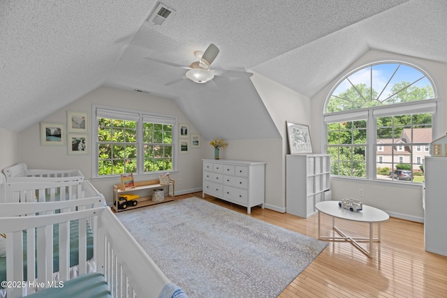 1005 Cambridge Ct, Trent Woods, NC 28562 - bedroom with vaulted ceiling, wood finished floors, a textured ceiling, baseboards, and a ceiling fan