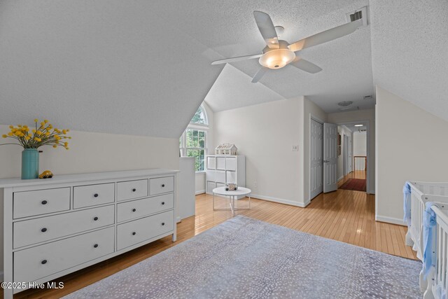 1005 Cambridge Ct, Trent Woods, NC 28562 - bedroom featuring wood finished floors, lofted ceiling, baseboards, a textured ceiling, and ceiling fan