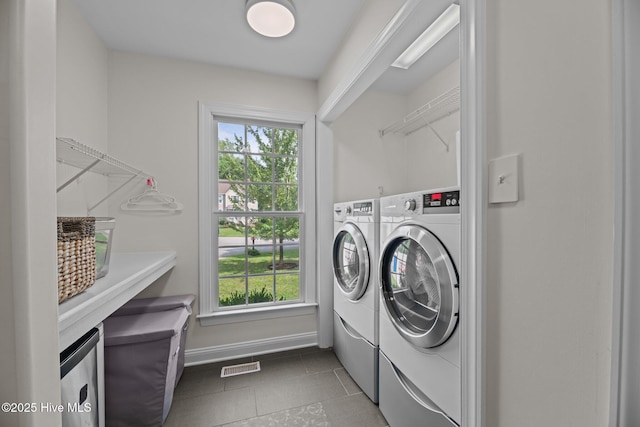 1005 Cambridge Ct, Trent Woods, NC 28562 - laundry area featuring washer and dryer, healthy amount of natural light, tile patterned flooring, and baseboards