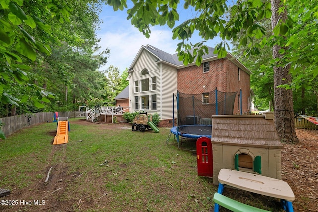1005 Cambridge Ct, Trent Woods, NC 28562 - rear view of property with a trampoline and a deck