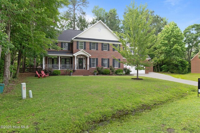 1005 Cambridge Ct, Trent Woods, NC 28562 - view of front of property with brick siding, concrete driveway, a porch, and a front yard