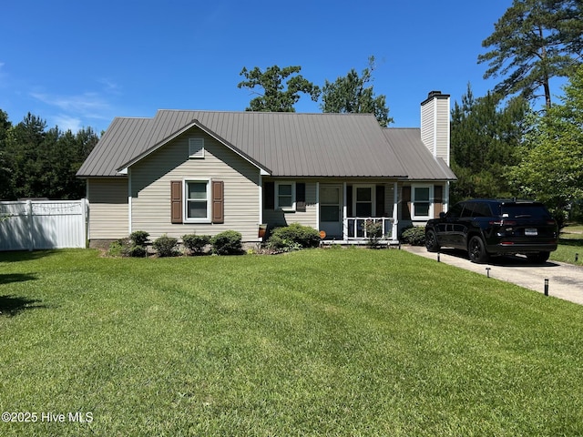 ranch-style home featuring covered porch, metal roof, and a chimney