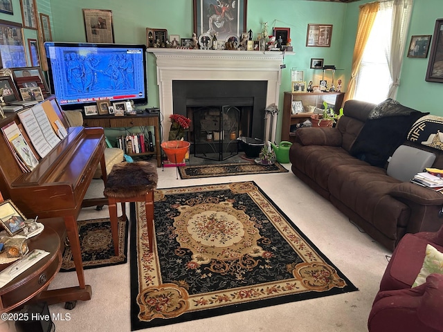 living area featuring a fireplace with flush hearth and carpet flooring