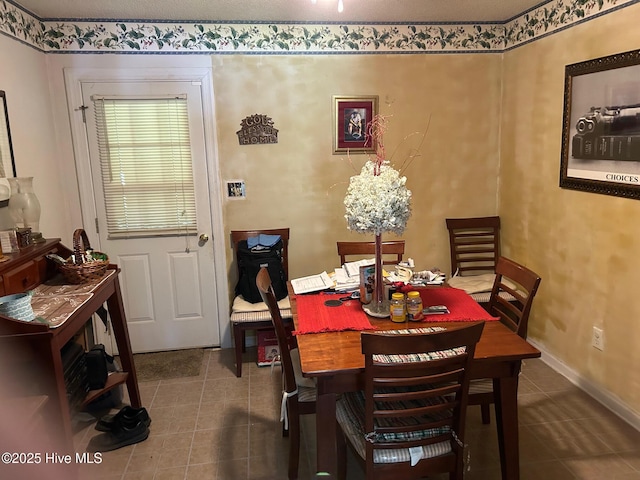 dining space with tile patterned flooring and baseboards