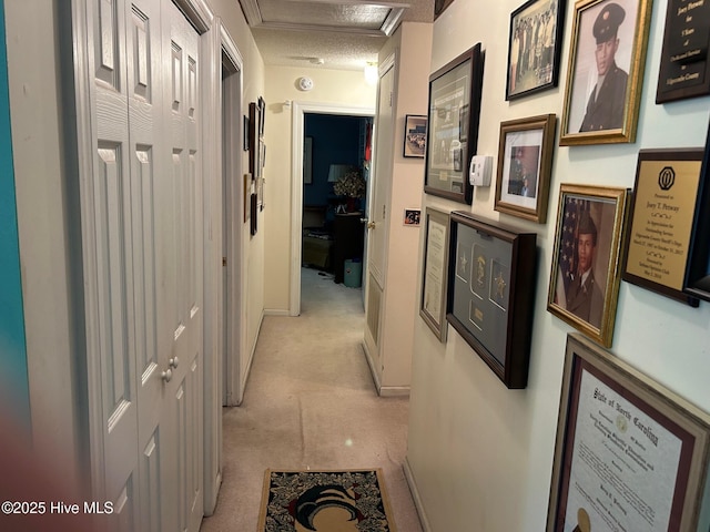 hall with a textured ceiling