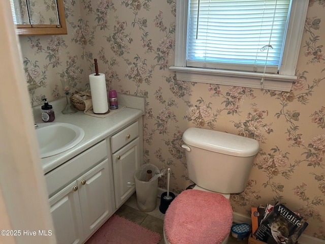 bathroom featuring vanity, tile patterned flooring, and toilet