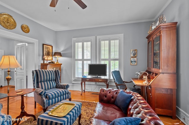 living room with a ceiling fan, wood finished floors, and ornamental molding