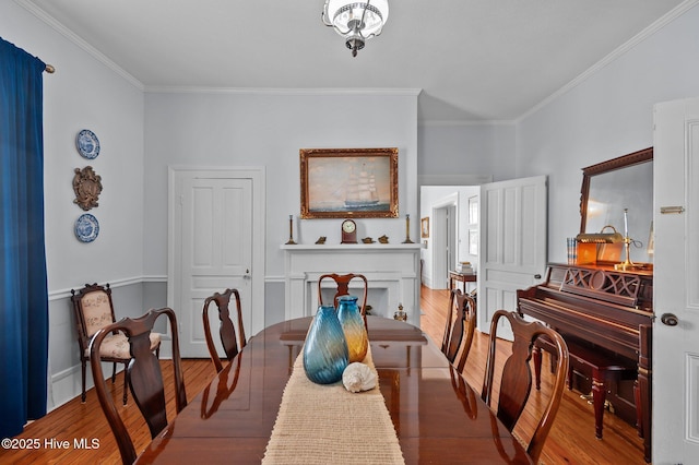 dining area with ornamental molding and wood finished floors