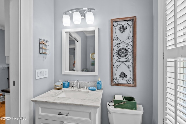 half bathroom featuring toilet and vanity