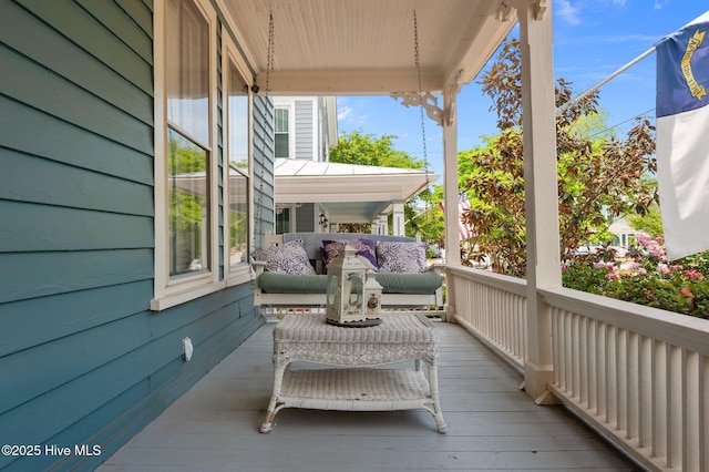 wooden terrace with an outdoor living space
