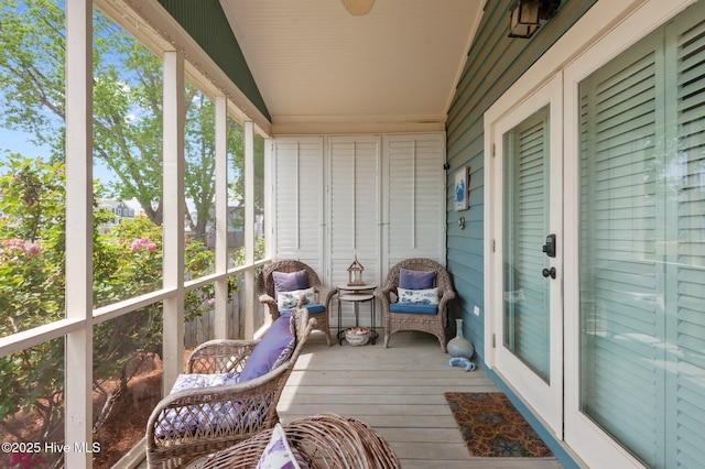 sunroom / solarium featuring lofted ceiling