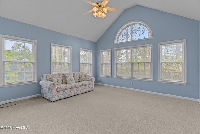 living room with carpet flooring, a ceiling fan, baseboards, and high vaulted ceiling