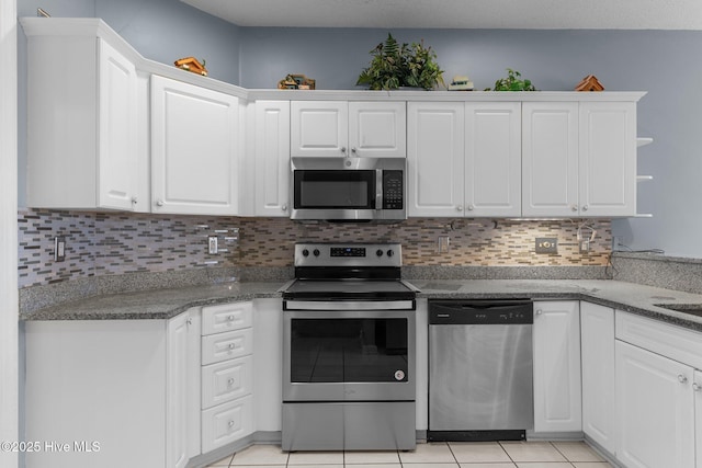 kitchen featuring stainless steel appliances and white cabinetry