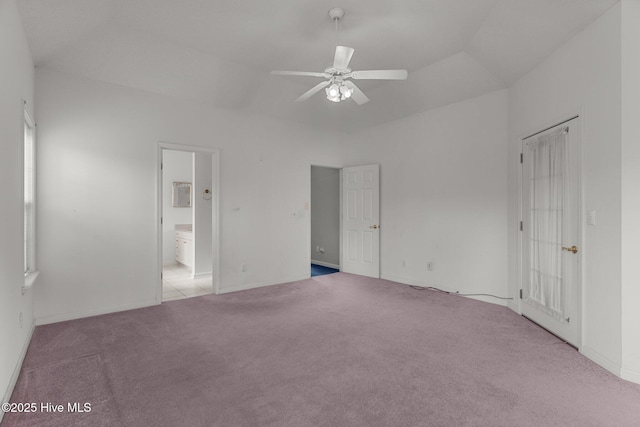 unfurnished bedroom featuring carpet flooring, ensuite bathroom, and ceiling fan