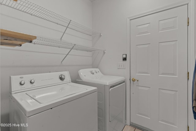 clothes washing area with independent washer and dryer