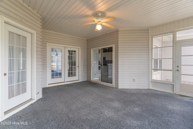 unfurnished sunroom featuring ceiling fan
