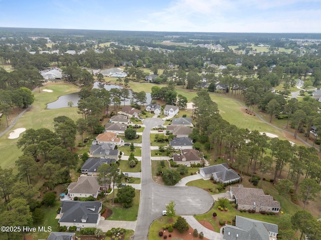 aerial overview of property's location with nearby suburban area, a nearby body of water, and a golf course