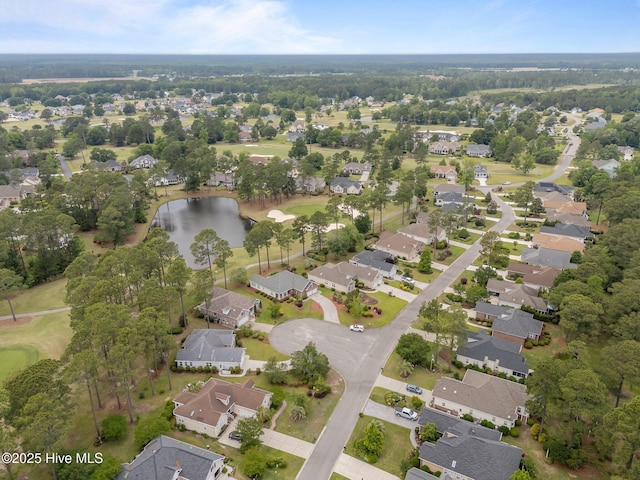 view of property location featuring nearby suburban area, a large body of water, and a golf course