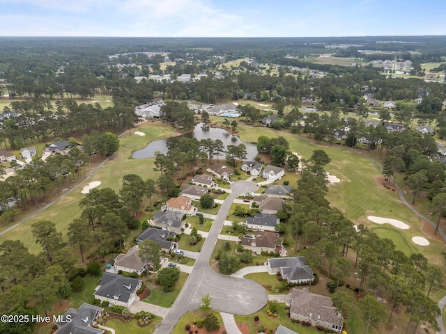 view of property location with nearby suburban area, a large body of water, and a golf club