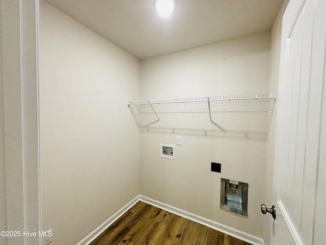 laundry area with dark wood finished floors, washer hookup, and baseboards