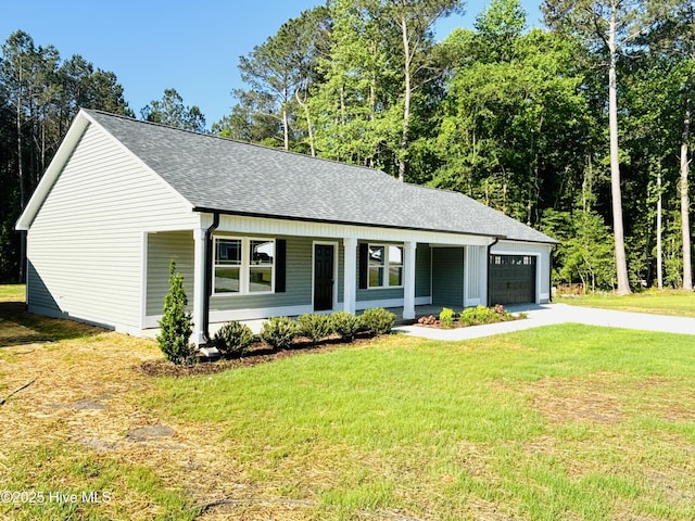 view of front of property featuring a garage, a shingled roof, a front yard, and driveway