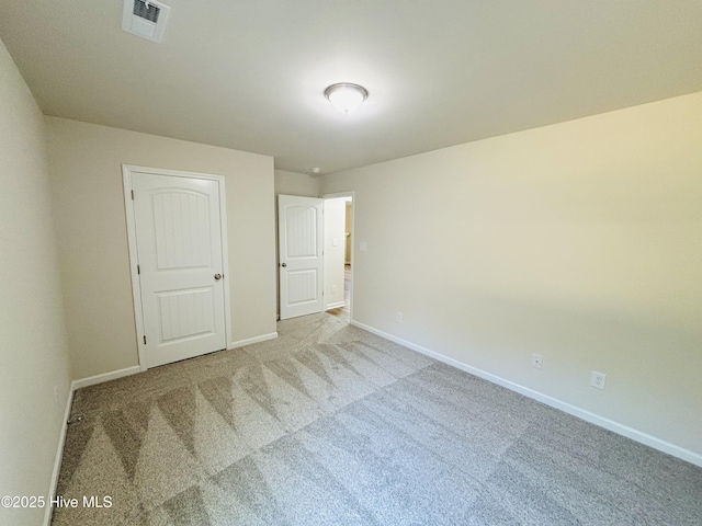 unfurnished bedroom featuring carpet and baseboards