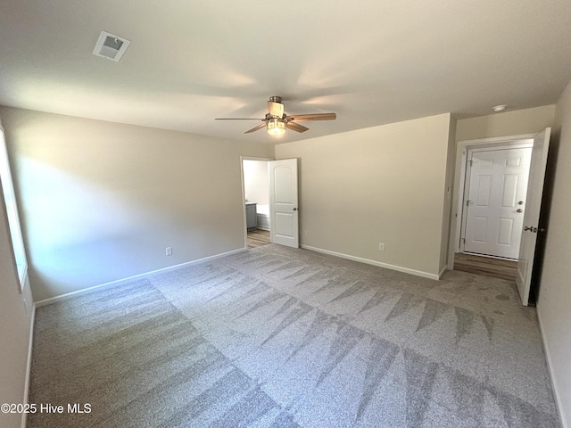 unfurnished bedroom with carpet, baseboards, and a ceiling fan