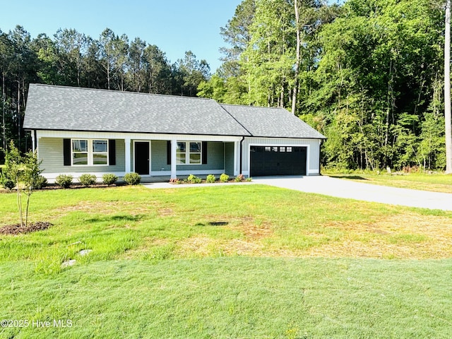 view of front of house with driveway, an attached garage, covered porch, a front yard, and roof with shingles