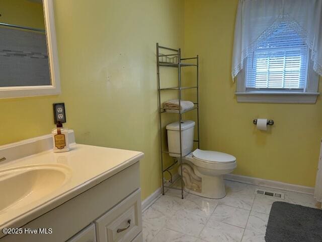 8019 W Tarboro Rd, Rocky Mount, NC 27803 - bathroom with vanity, marble look tile flooring, baseboards, and toilet