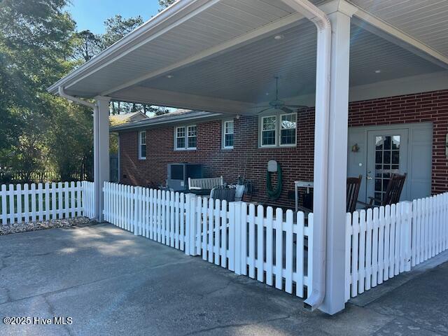 8019 W Tarboro Rd, Rocky Mount, NC 27803 - view of side of property with ceiling fan, brick siding, an attached carport, and a patio