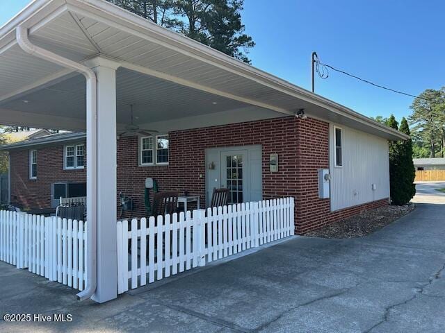 8019 W Tarboro Rd, Rocky Mount, NC 27803 - view of side of home with ceiling fan, a carport, and brick siding