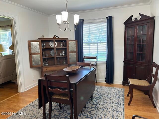 8019 W Tarboro Rd, Rocky Mount, NC 27803 - dining room with a chandelier, light wood-type flooring, plenty of natural light, crown molding, and baseboards