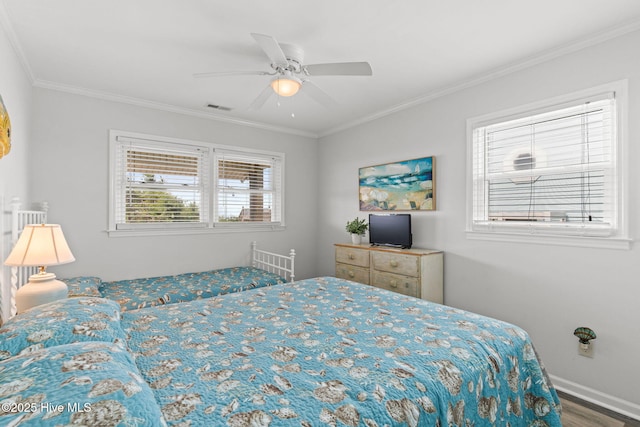 bedroom with ornamental molding, wood finished floors, baseboards, and ceiling fan