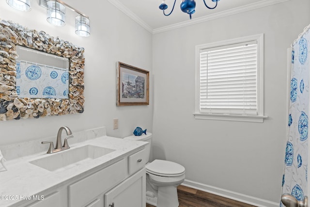bathroom featuring crown molding, wood finished floors, vanity, toilet, and baseboards