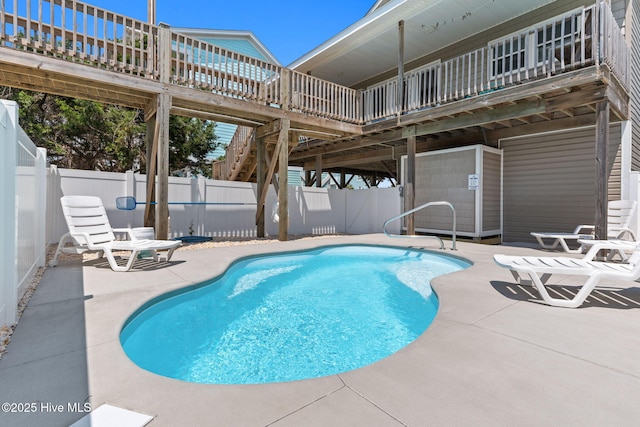 view of pool with a patio area, a fenced backyard, and a wooden deck