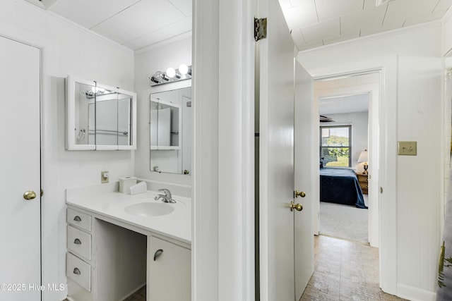 bathroom with ornamental molding and vanity