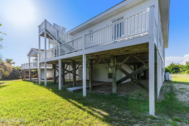 317 Sand Piper Ln, Holden Beach, NC 28462 - rear view of property with a wooden deck and a yard