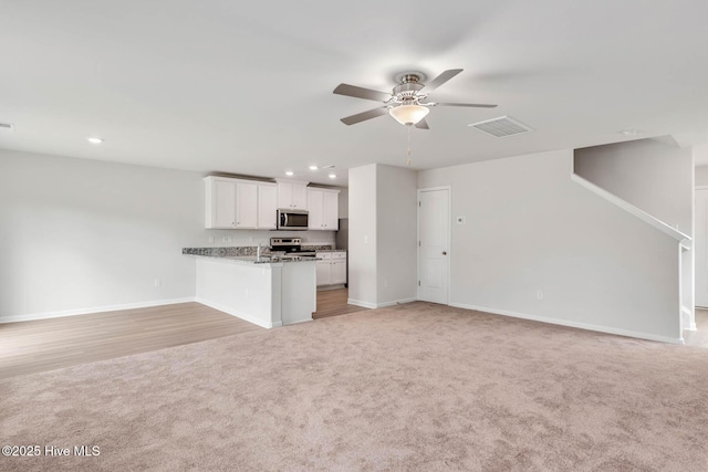 1571 Gate Hill Rd SE, Bolivia, NC 28422 - unfurnished living room with light colored carpet, ceiling fan, baseboards, and recessed lighting