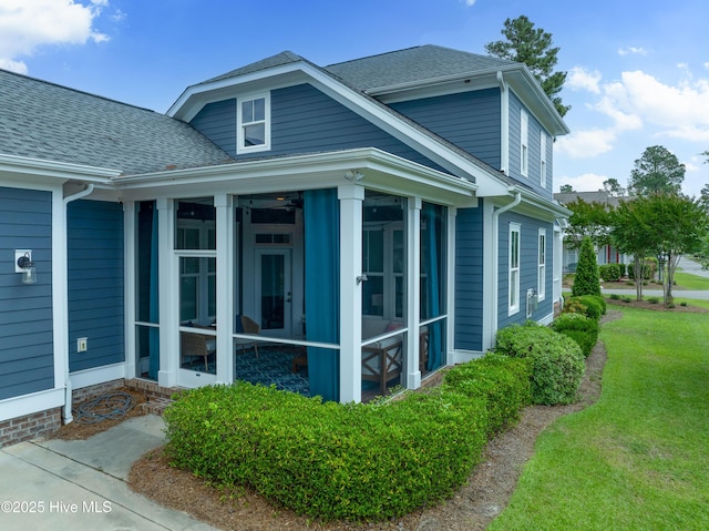 212 Cornubia Dr, Castle Hayne, NC 28429 - view of side of property featuring a sunroom, a shingled roof, and a yard