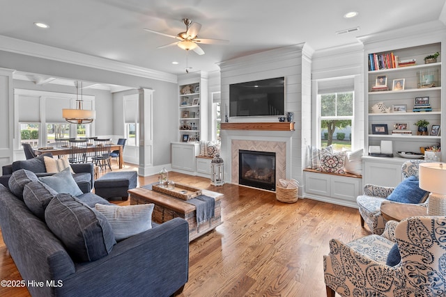 212 Cornubia Dr, Castle Hayne, NC 28429 - living area featuring ceiling fan, crown molding, healthy amount of natural light, light wood-style floors, and a fireplace