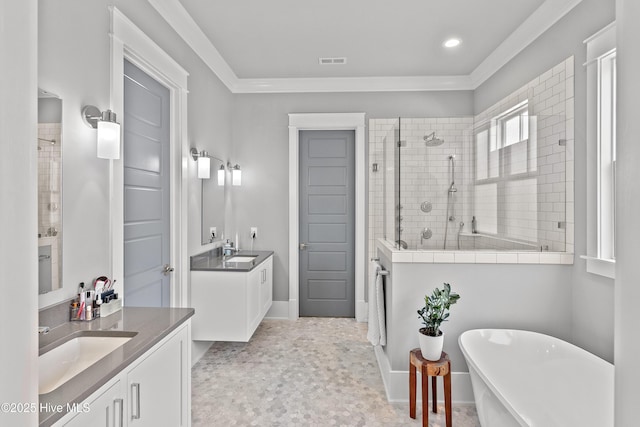 212 Cornubia Dr, Castle Hayne, NC 28429 - bathroom with a soaking tub, a stall shower, two vanities, crown molding, and recessed lighting