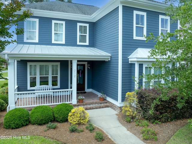 212 Cornubia Dr, Castle Hayne, NC 28429 - view of front of property with covered porch, a standing seam roof, a metal roof, and roof with shingles