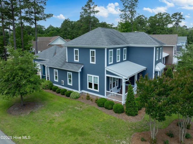 212 Cornubia Dr, Castle Hayne, NC 28429 - view of front of house with a front yard, covered porch, a shingled roof, and view of scattered trees
