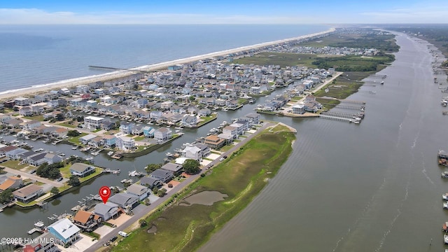 aerial overview of property's location with a nearby body of water and nearby suburban area