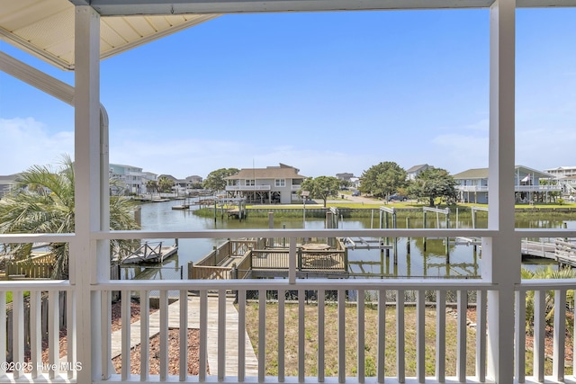 wooden deck featuring a water view and a residential view