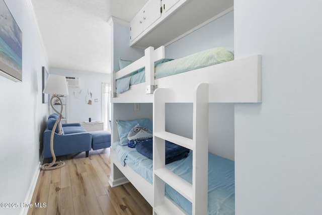 bedroom featuring wood finished floors and baseboards