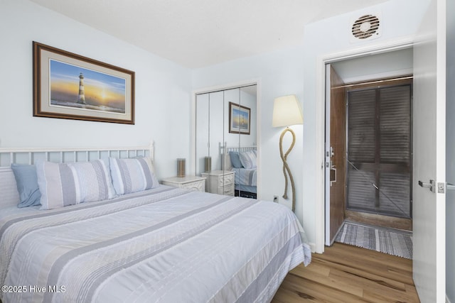 bedroom featuring wood finished floors and a closet