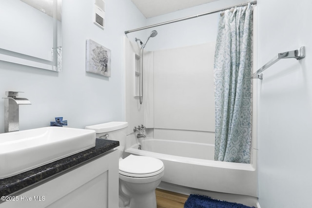 full bath featuring shower / bath combo, toilet, vanity, and wood finished floors