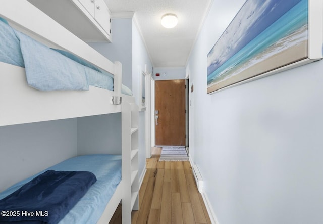hall with crown molding and light wood finished floors