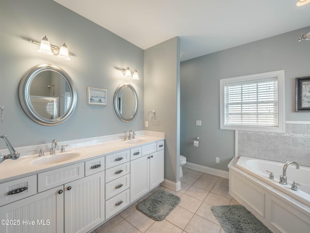 4388 Island Dr, North Topsail Beach, NC 28460 - bathroom featuring tile patterned flooring, double vanity, a bath, toilet, and baseboards